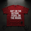 Red heavyweight tee with bold white SOFT ON THE OUTSIDE FERAL ON THE INSIDE typography