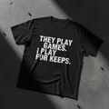 Black heavyweight tee with bold white THEY PLAY GAMES I PLAY FOR KEEPS typography