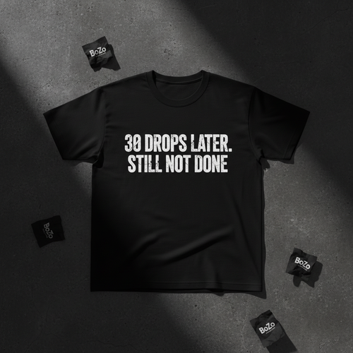 Black heavyweight tee with bold white 30 DROPS LATER STILL NOT DONE typography