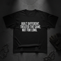 Black heavyweight tee with bold white typography - Built Different Treated The Same Not For Long