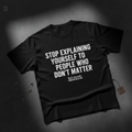 Black heavyweight tee with bold white STOP EXPLAINING YOURSELF typography